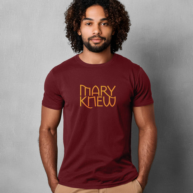 Man wearing a maroon t-shirt with 'MARY KNEW' text against a gray background