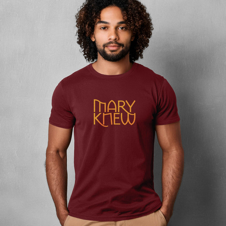 Man wearing a maroon t-shirt with 'MARY KNEW' text against a gray background