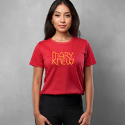 Female wearing a red t-shirt with 'MARY KNEW' text on a gray background