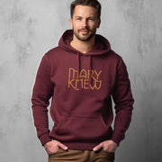 Man wearing a maroon hoodie with 'Mary Knew' text on a gray background