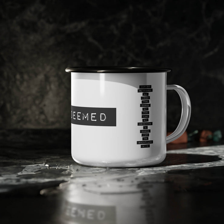 White campsite mug on countertop with REDEEMED graphic based on Galatian 3:13