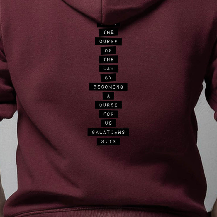 Maroon pullover hoodie with Redeemed graphic based on Galatians 3:13