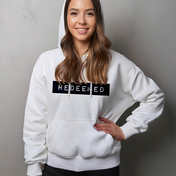 White pullover hoodie with Redeemed graphic based on Galatians 3:13