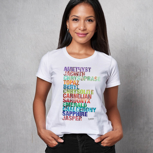 Woman wearing a white t-shirt with colorful gemstone names on a gray background