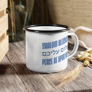 White mug with blue text 'Shalom Aleichem' and 'Peace Be Upon You' on a wooden surface